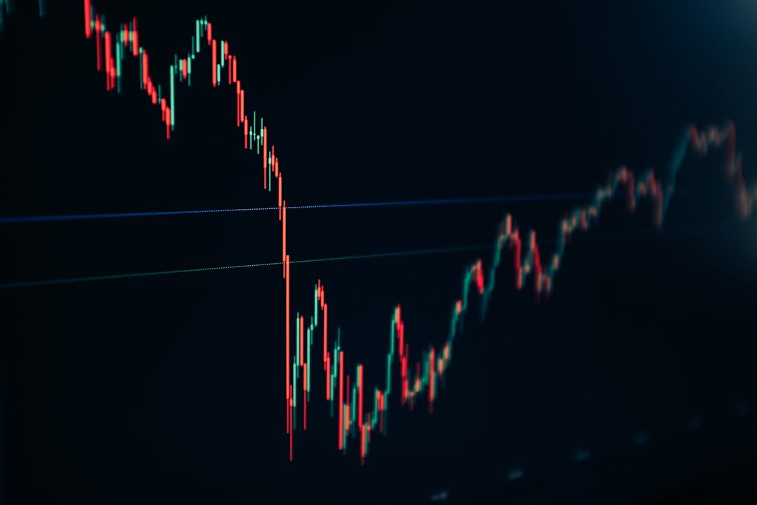 Candlestick stock chart on a dark screen